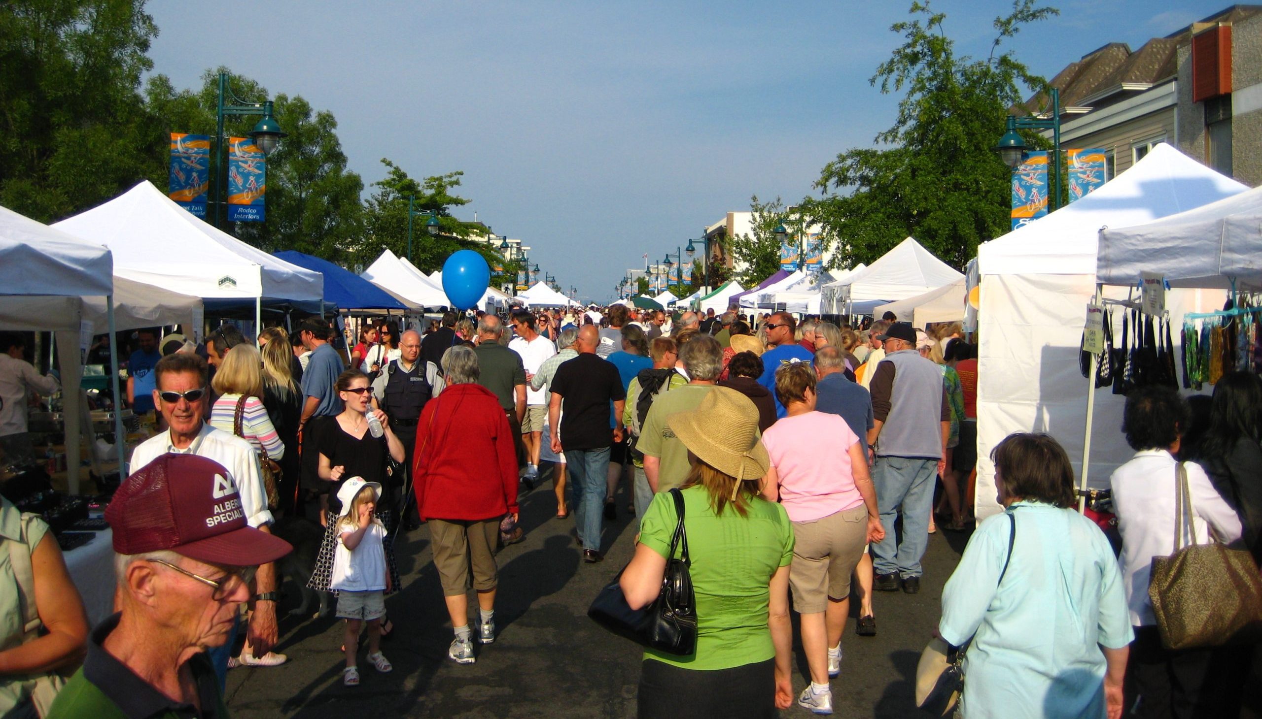 People walking between tents at market