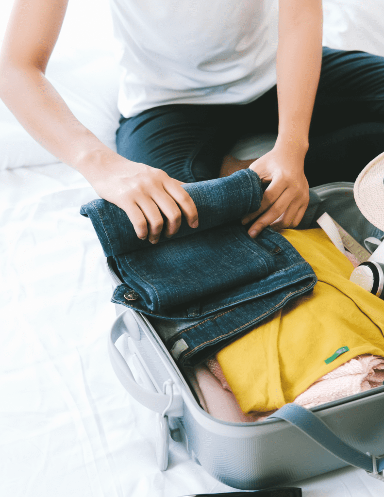 Person packing a suitcase